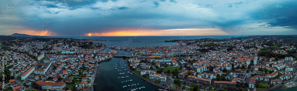 Fototapeta premium Panorama of Sunset over Saint-Jean-de-Luz from a drone, Nouvelle-Aquitaine, Pyrenees-Atlantiques, France, Europe
