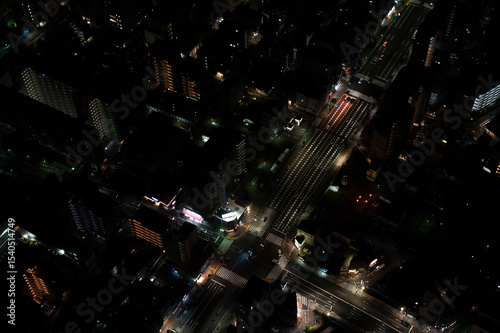 Aerial view of cross street at night in Tokyo, Japan.