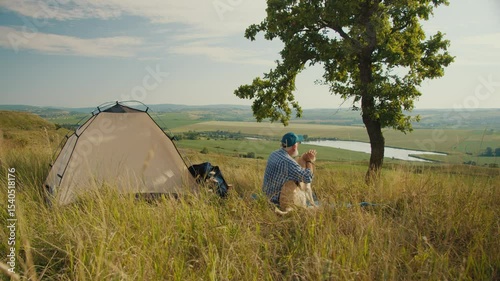 Digital Detox, Nature Healing. Senior Man Sits With His Dog by a Tent, Admiring the Mountain View. A Quiet Moment of Disconnection, Mental Recharging, and Deep Presence in Nature