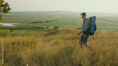 Purposeful Journey, Late-Life Exploration. Senior Man Hikes Through Panoramic Mountain Landscape, Surrounded by Trees, Grass, and Sky. A Soulful Adventure Embracing Nature and Personal Growth in Later
