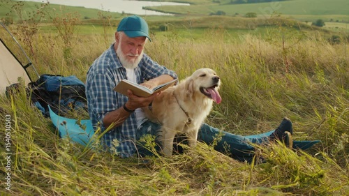 Quiet Retirement, Mindful Aging, Pet Bonding. Senior Man Sits Beside Tent With His Dog and Reads a Book in Nature. A Peaceful Moment of Reflection, Companionship, and Slow Outdoor Living