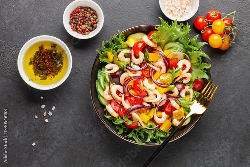 Easy  salad of fresh cucumber, tomato, sweet pepper, shrimps and onion . Healthy food. Top view