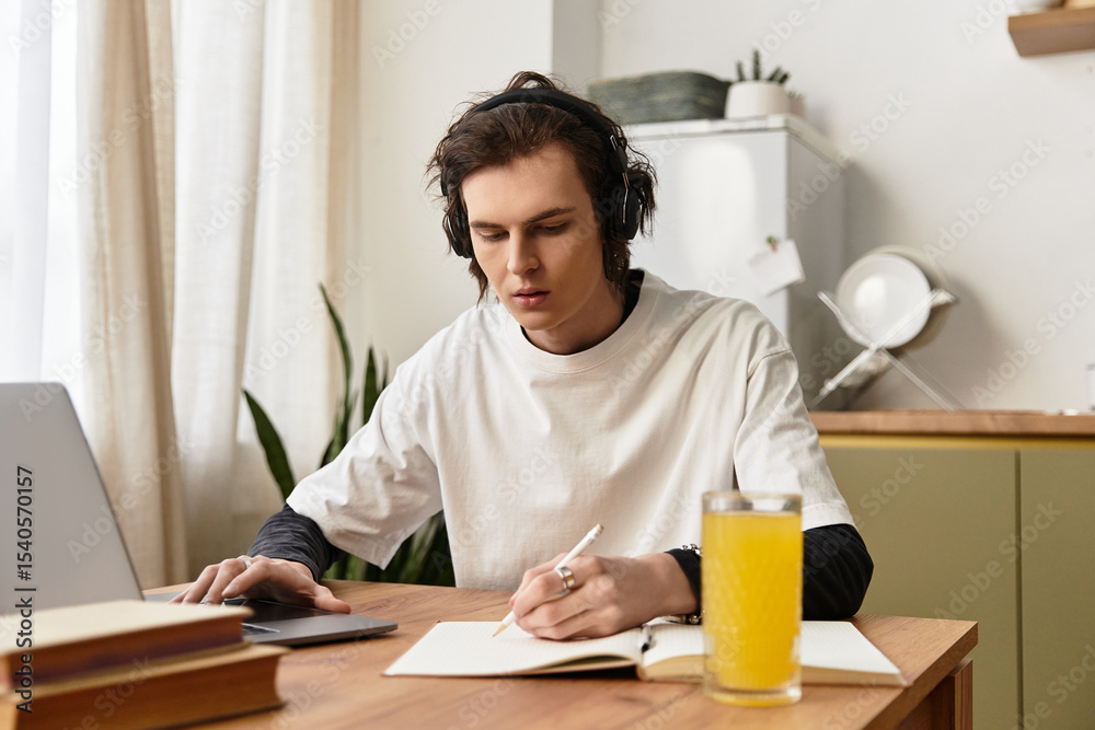 Young man enjoys a productive study session at home in comfortable attire Young man enjoys a productive study session at home in comfortable attire