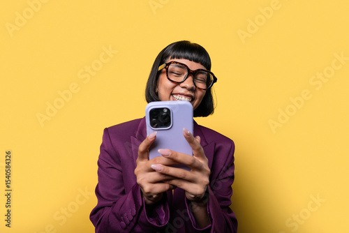 Hispanic woman smiling while using her smartphone