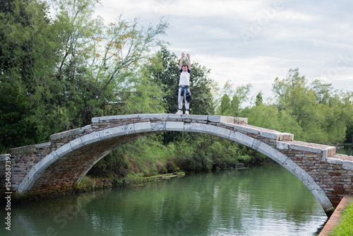 Boy enjoying bridge view on Murano and Burano island, Venice