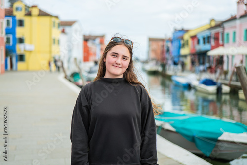 Teenager explores the colorful streets of Burano and Murano in Venice photo