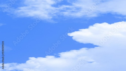 Clear sky with a cloud, Puffy fluffy white cloud n cotton candy cumulus cloudscape moving on beautiful sunny clear blue sky background in summer sunlight n sun ray at sunshine day.