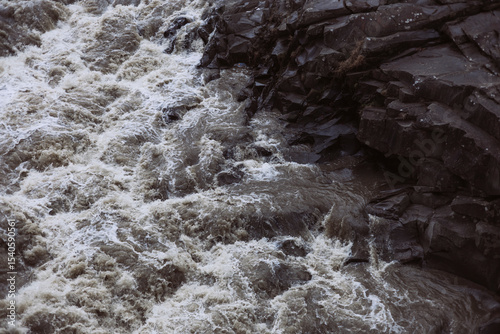 Scenic view of rushing mountain river against rocks