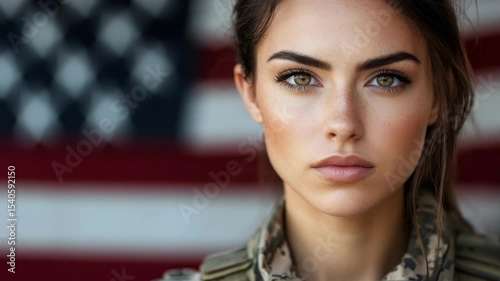 A proud American female soldier in uniform stands strong against the national flag, embodying patriotism and resilience.