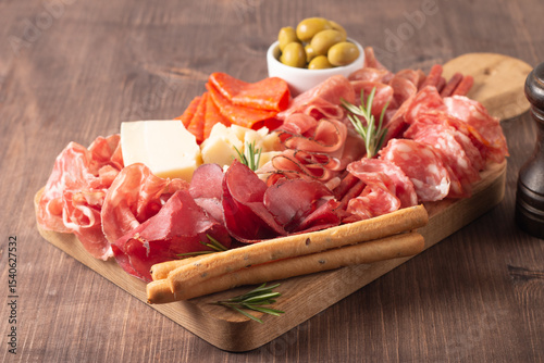 Charcuterie board. Antipasti appetizers of meat platter with salami, prosciutto crudo or jamon and olives.