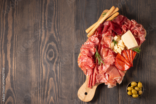Charcuterie board. Antipasti appetizers of meat platter with salami, prosciutto crudo or jamon and olives.