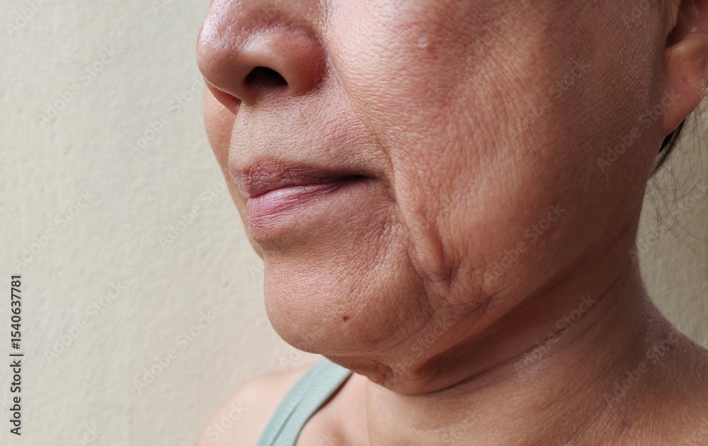 Obraz premium portrait the wrinkle and Flabby skin, smile lines and Flabbiness beside the mouth, dark spots and blemish, freckles and scar on the face of the woman, health care and beauty concept.