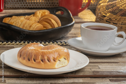 Still life of Colombian roscón with sandwich and arequipe accompanied by coffee