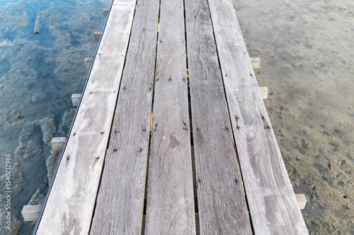 Wooden jetty walkway over shore