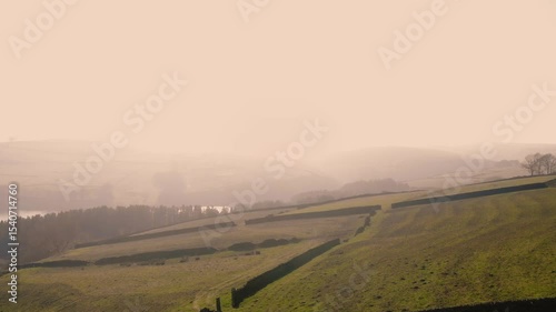 Countryside farmland in Peak District National Park on misty day landscape