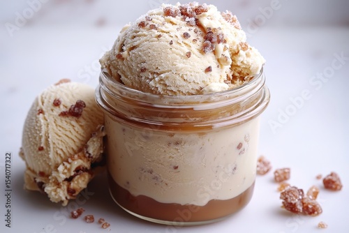 Indulgent caramel crunch ice cream in a jar with sprinkled toppings