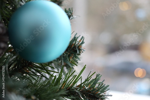Fir branch with balls and festive lights.