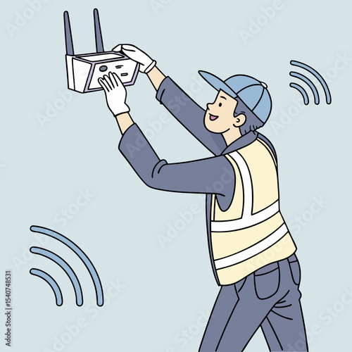 Wireless internet installation in progress with a technician fixing a router on a blue wall in a modern interior.