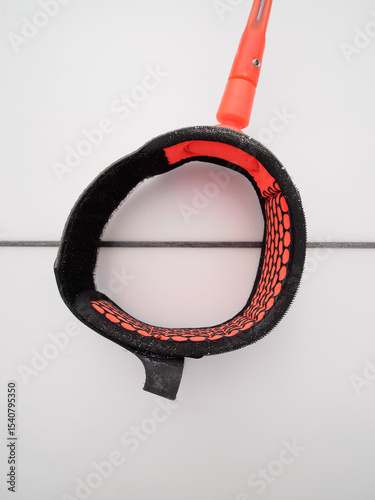 Orange color surfboard leash. Close-up.