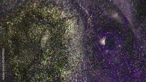 A macro capture of glitter particles forming a vortex-like motion in deep purple tones. Reflective particles shine under soft lighting.