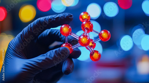 Scientist holding a molecular model in a laboratory setting