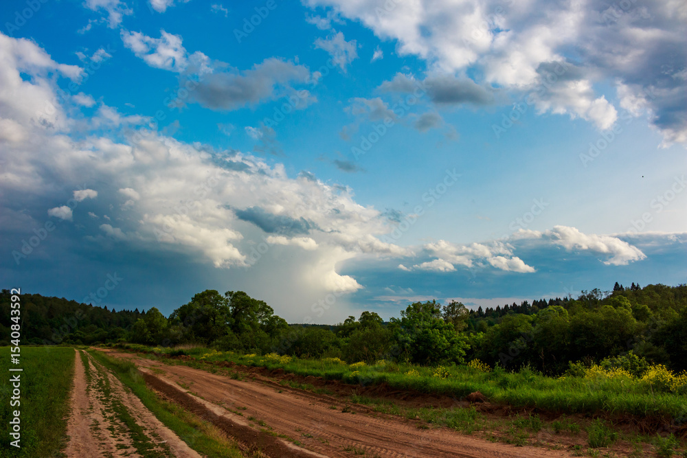 Obraz premium Cumulonimbus clouds approaching on blue sky, cloudscape before rain