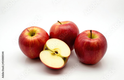 Fresh Jonagold and Pinova apples on white background. Red fruit sliced shows juicy flesh. Healthy eating, diet and vitamins concept. Perfect for product presentation, recipe illustrations.