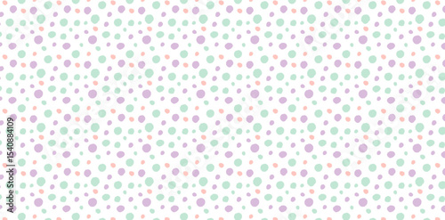 Pattern of multicolored pastel dots in green, pink, and purple on white background. Abstract polka dot texture.