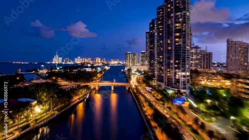 Wallpaper Mural Aerial view of modern city skyline at twilight hour with water canal and traffic trails near tall buildings and condominiums Torontodigital.ca