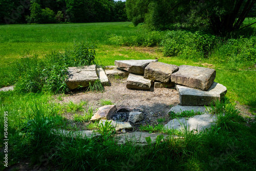 Firepit with bench and Rock Seats near a little River in the bavarian Forests Germany