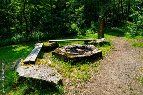 Firepit with bench and Rock Seats near a little River in the bavarian Forests Germany