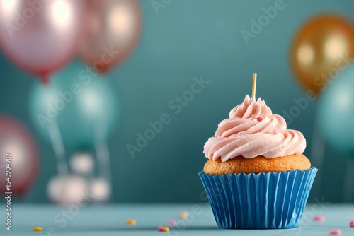 Colorful Cupcake With Pink Frosting and Balloons on a Festive Table.