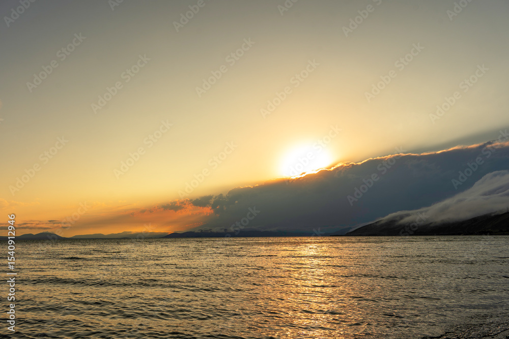 Fototapeta premium Beautiful sunset with clouds over the lake.