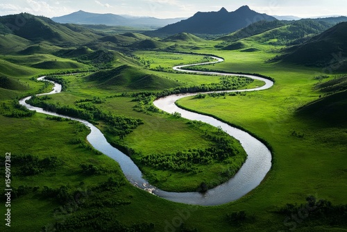 Scenic View of a Winding River Through Lush Green Valley in Mountainous Lands...