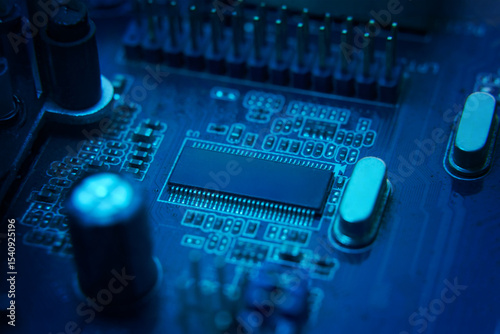 Here is a detailed view of a bluelit circuit board that showcases intricate and complex electronic components