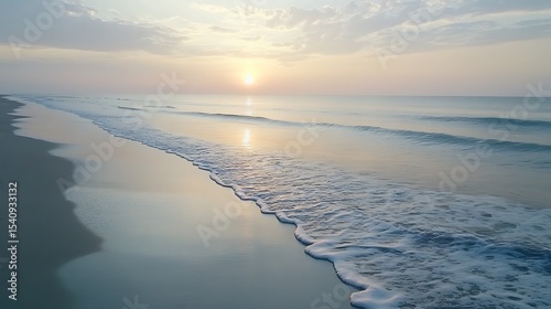 A peaceful sunrise over the beach with soft pastel tones reflecting on the gentle waves.