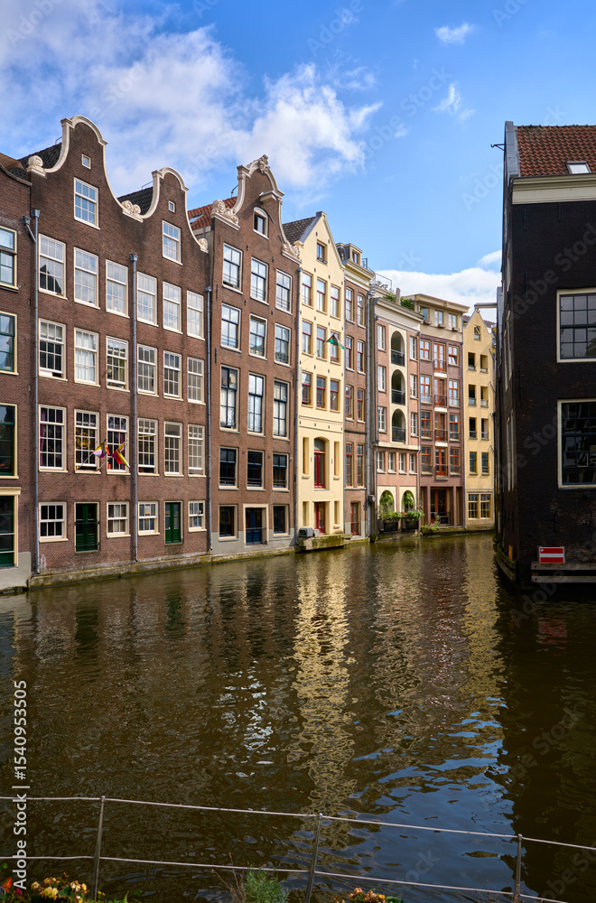 Naklejka premium Oudezijds Voorburgwal Canal De Wallen Amsterdam. De Wallen houses on the Oudezijds Voorburgwal Canal near the Red-Light district in Amsterdam.