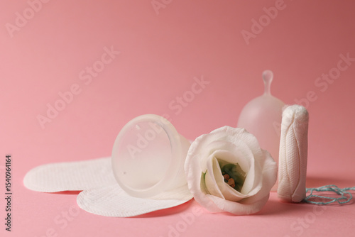 Eco-friendly menstrual cup and other feminine hygiene products on a bright background