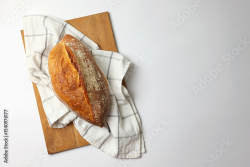 Beautiful and delicious artisan bread on a light background, top view