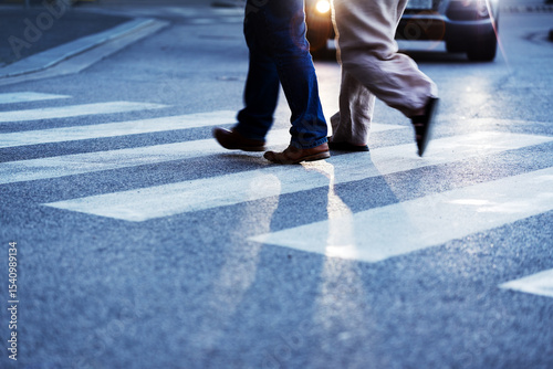 Legs of couple crossing the street