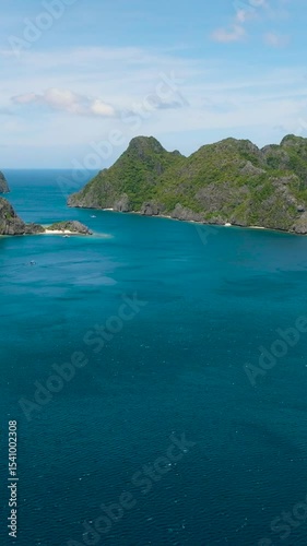 Tropical Islands with white sand beach and splendid limestone rocks formation. El Nido, Palawan. Philippines. Vertical view.
