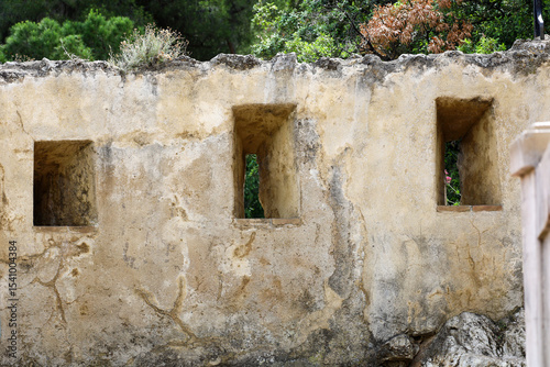 The medieval style fortification wall with windows on the path to the Prince's Palace in Monaco.