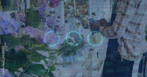 Scanning florist in plaid shirt and apron using tablet at counter, with hydrangeas copy space