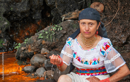 Wallpaper Mural Indigenous woman wearing traditional clothes collecting water from a stream Torontodigital.ca
