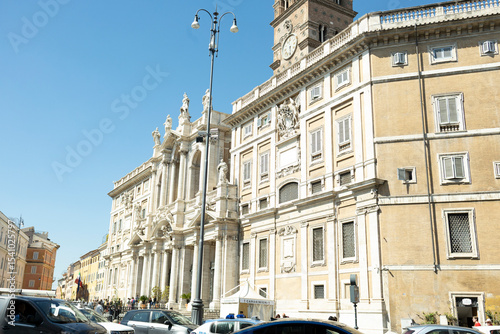 View of the Papal Basilica of Santa Maria Maggiore and its clock, from Piazza Santa Maria Maggiore, on a sunny day.