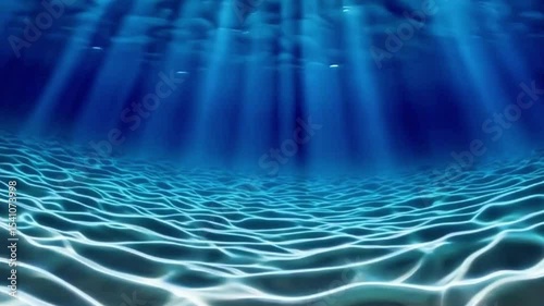 seamless loop of deep blue ocean waves from underwater background, light rays shining through