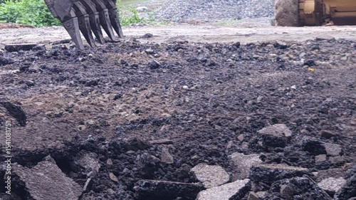 Heavy construction equipment work tirelessly on the road, where industrial machines and vehicles handle asphalt, pavement repair, and earth-moving activities as part of large-scale engineering.