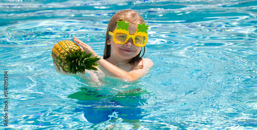 Happy child playing in swimming pool. Summer kids vacation.