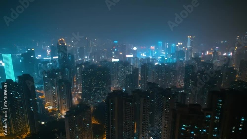 Foggy city skyline with bright illuminated buildings at night