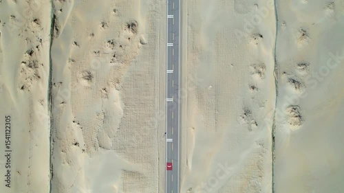 Drone view of asphalt road passing through in Gobi desert on sunny autumn day in Hotan, Kashgar, Xinjiang, China, 4k real time footage, travel concept. 